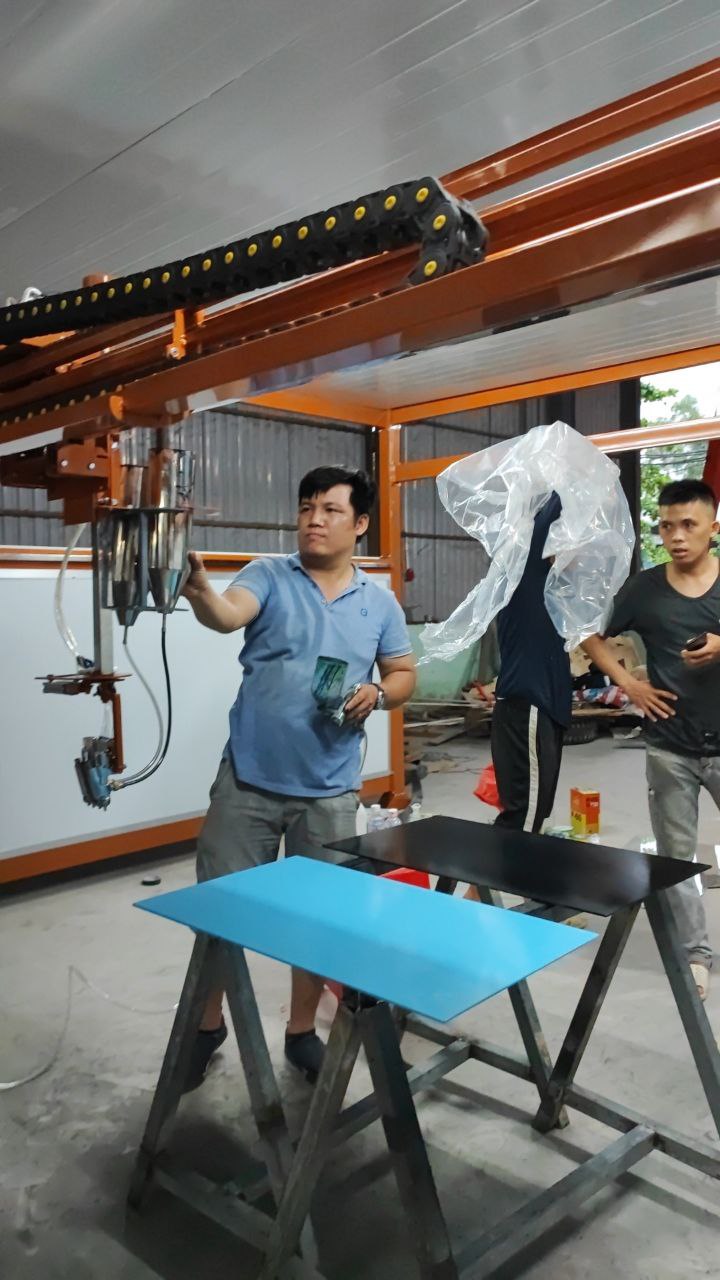 Kỹ thuật viên kiểm tra cụm béc phun khi bảo trì máy phun sơn tự động